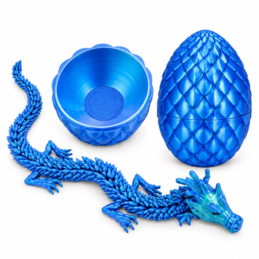 Blue articulated dragon beside an open scale-patterned dragon egg